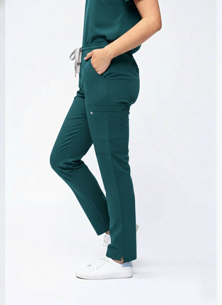 Person wearing a green scrub set on a white background