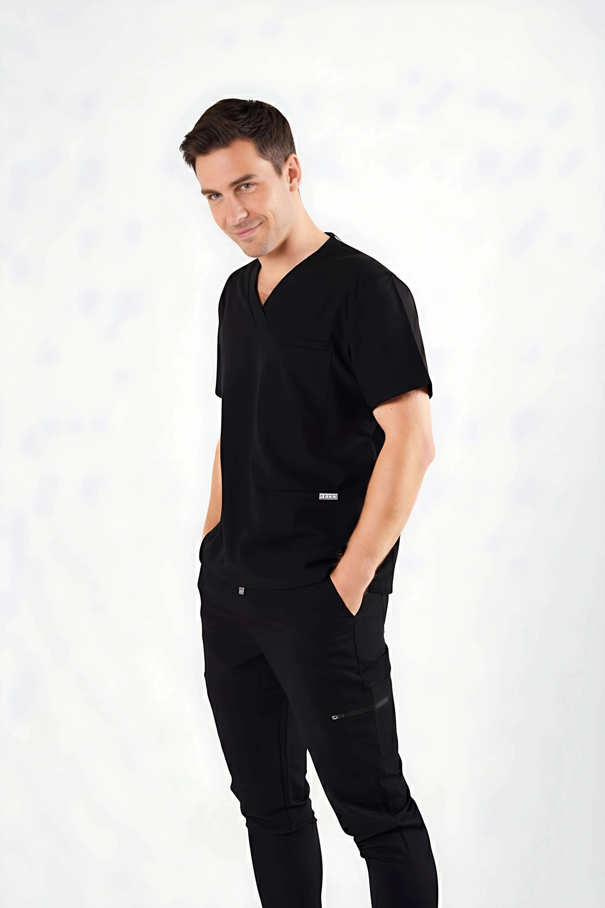 Man wearing a black scrub set on a white background