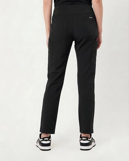 Rear view of a person wearing black cargo-style pants with side pockets and black sneakers against a plain light background.