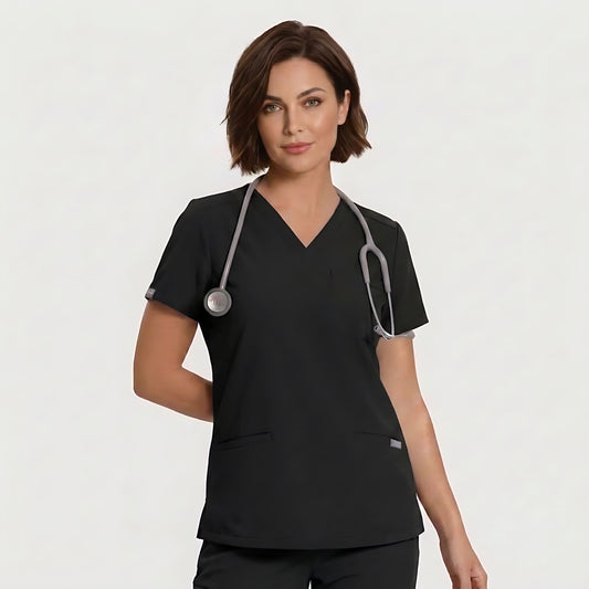 A woman wearing a black V-neck scrub top with a gray stethoscope around her neck, photographed against a clean light gray studio background.