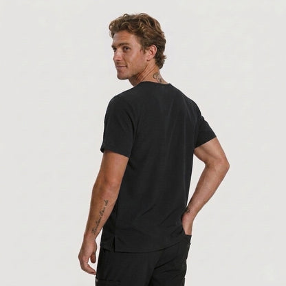 Man wearing a black t-shirt and pants on a plain background