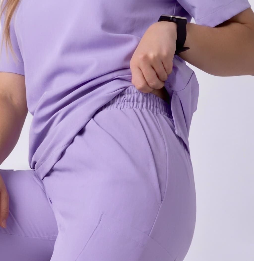 Person wearing a purple outfit with a white background