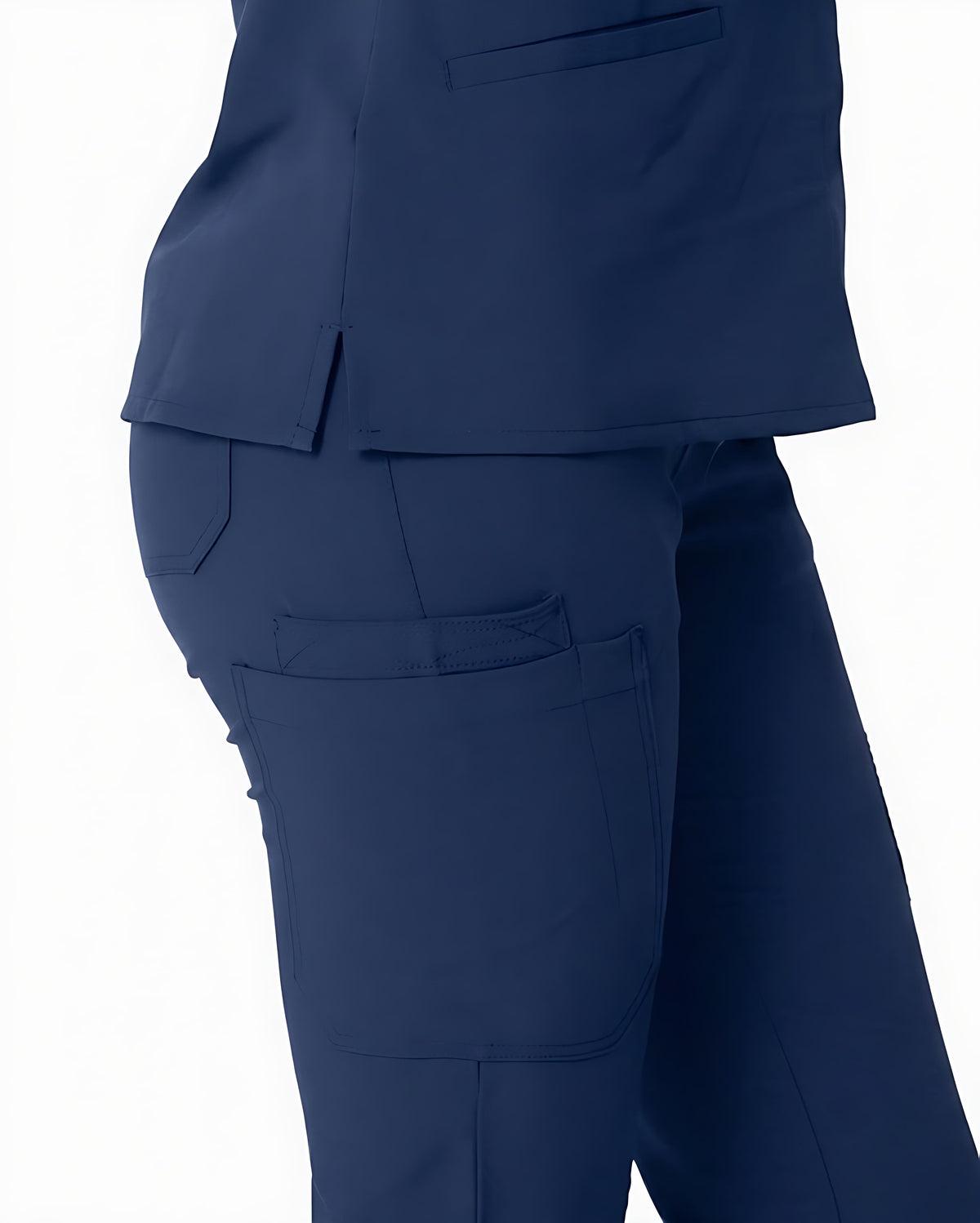 Close-up of a navy blue scrub set, showing the side and back of a cropped scrub top with a matching cargo-style scrub pant featuring a large patch pocket.