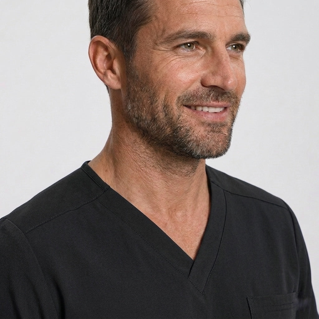 Man wearing a black shirt against a plain background