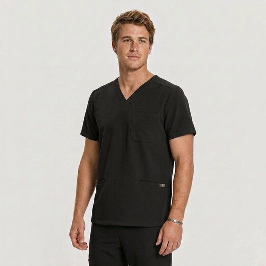 Man wearing a black scrub top against a plain background