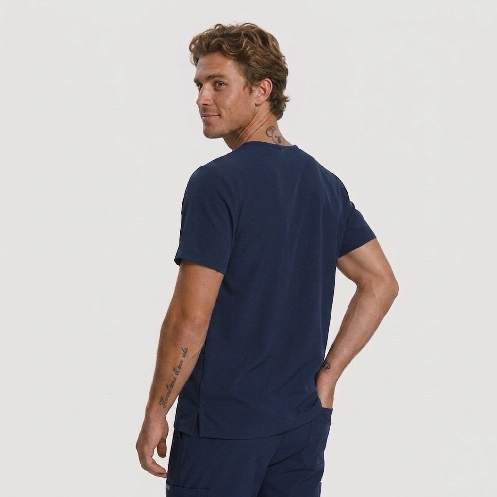 Man wearing a navy blue t-shirt and shorts on a light gray background