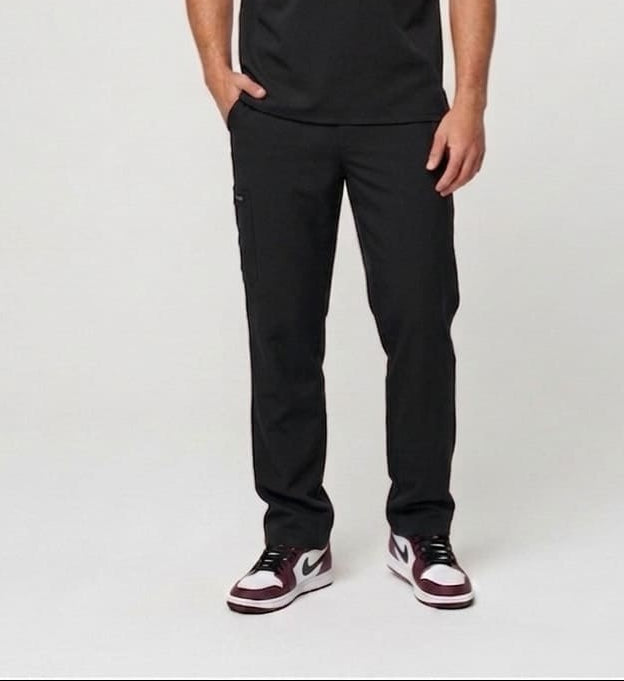 Man wearing a black V-neck t-shirt and black pants on a white background