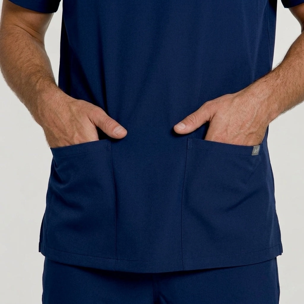 Navy blue scrub set with pockets on a plain background