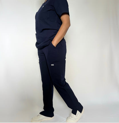 Fitix navy scrub with multiple pockets wearing by a nurse in a clean white background.