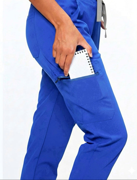 Person wearing blue scrubs with a notepad in the pocket on a white background