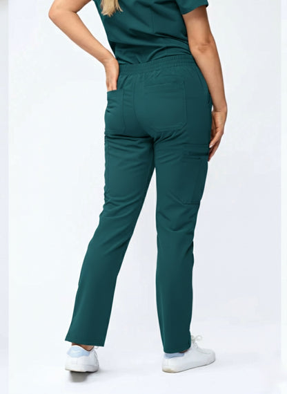 Person wearing teal scrubs with a white background