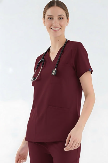 Person wearing a burgundy scrub top with a stethoscope on a white background