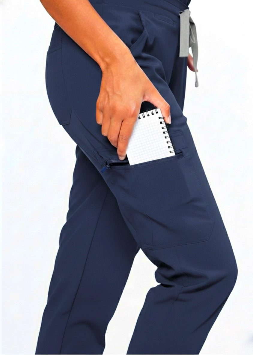 Navy blue scrubs with a hand holding a notepad on a white background
